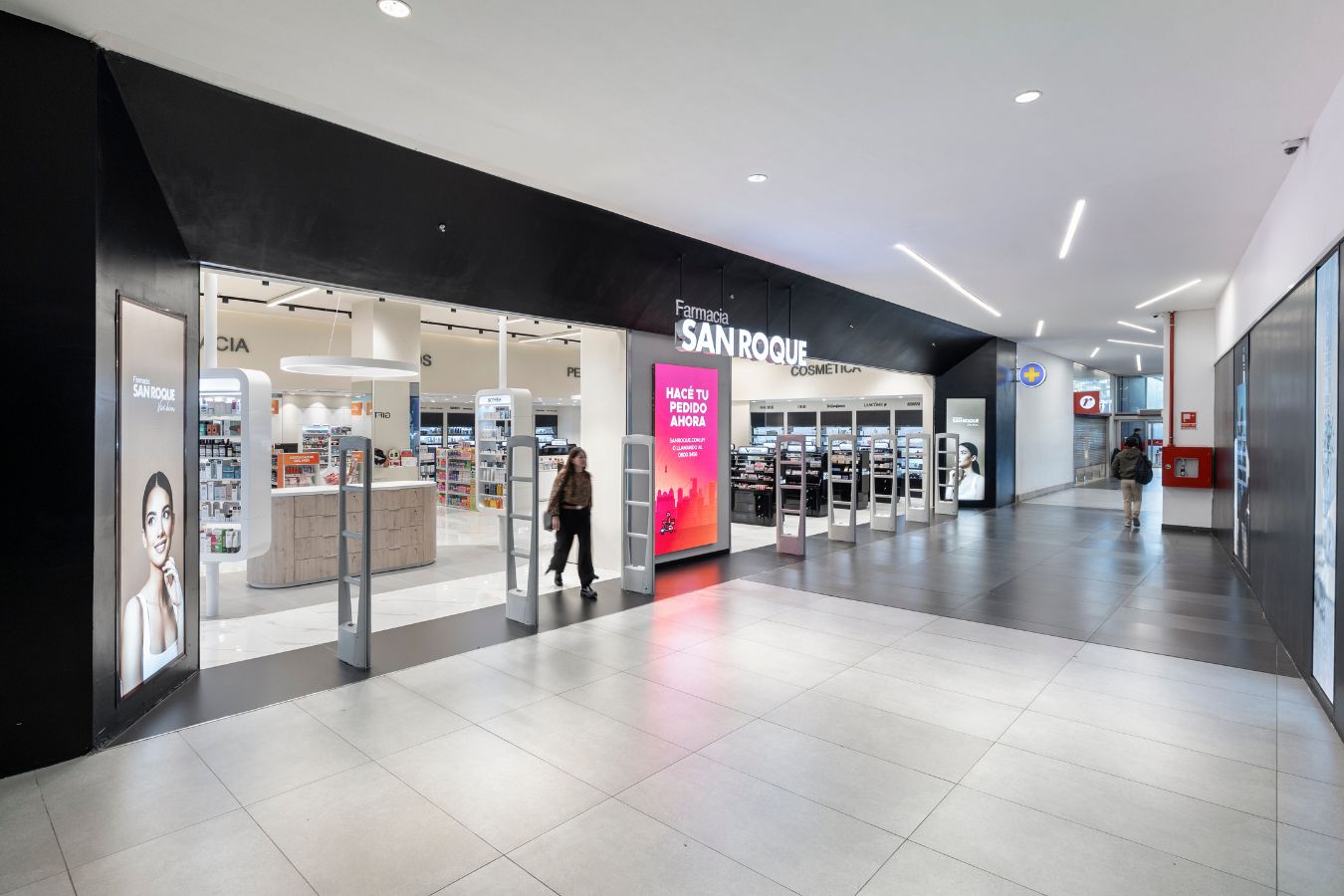 San Roque Pharmacy - Wide retail storefront with black facade and digital signage entrance - Contract Workplaces.jpg